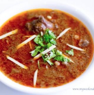 a white bowl filled with soup and meatballs