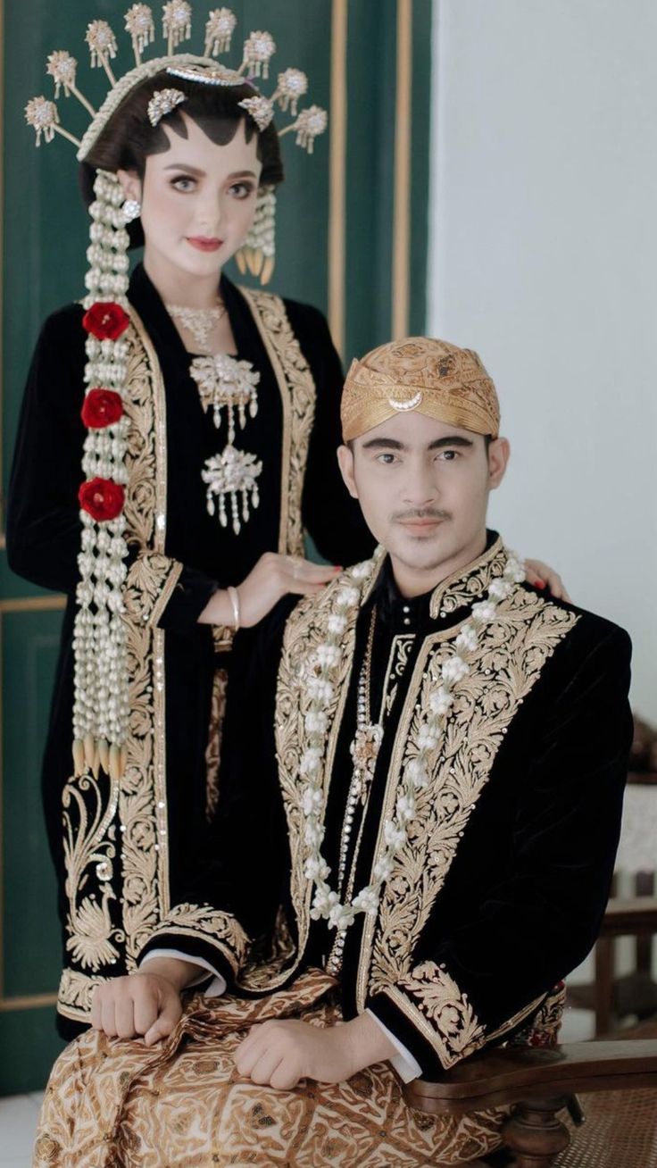 a man and woman dressed in traditional clothing