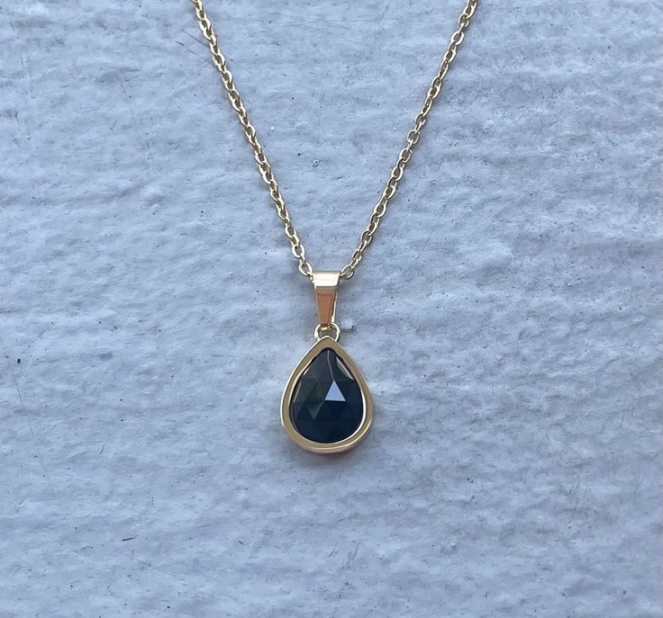 This necklace is handmade with a genuine black onyx stone. The necklace is made of stainless steel and plated with 18k gold. The chain length is 17 inches and can be adjusted to be shorter. This necklace is hypoallergenic. (Cadium free, lead free, and nickel safe) Black onyx is a protective stone that shields from negative energy and promotes strength. The necklace comes in a ribbon-wrapped box and is ready to be gifted. If you would like to leave a note, you can do so during checkout. Elegant Teardrop Stainless Steel Necklaces, Elegant Onyx Crystal Necklace For Gift, Black Onyx Gemstone Crystal Necklace, Luxury Onyx Pendant Necklace, Elegant Hand-strung Onyx Necklace, Black Onyx Pendant Crystal Necklace, Black Crystal Necklace, Scorpio Rising, Black Onyx Stone