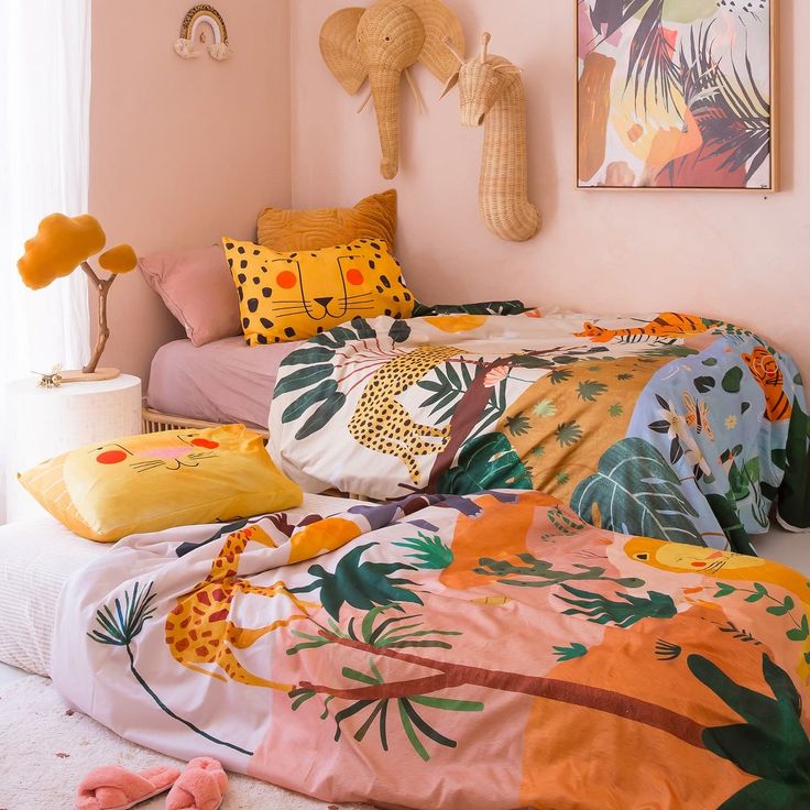 a bedroom with pink walls and colorful bedding