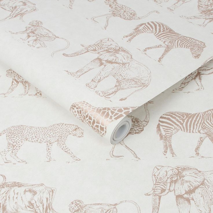 a wallpaper with zebras and giraffes on white paper, next to a roll of tape