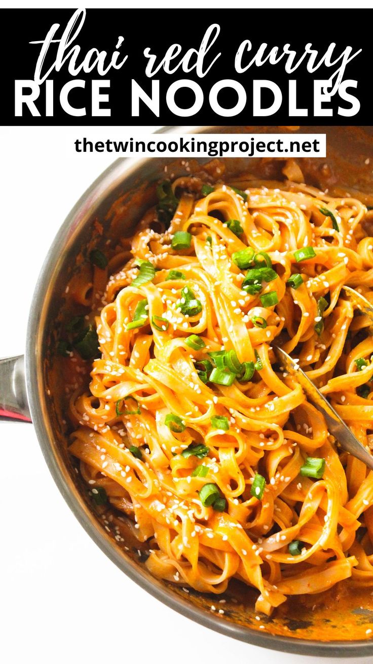 a skillet filled with noodles and sauce on top of a white table next to a red spoon