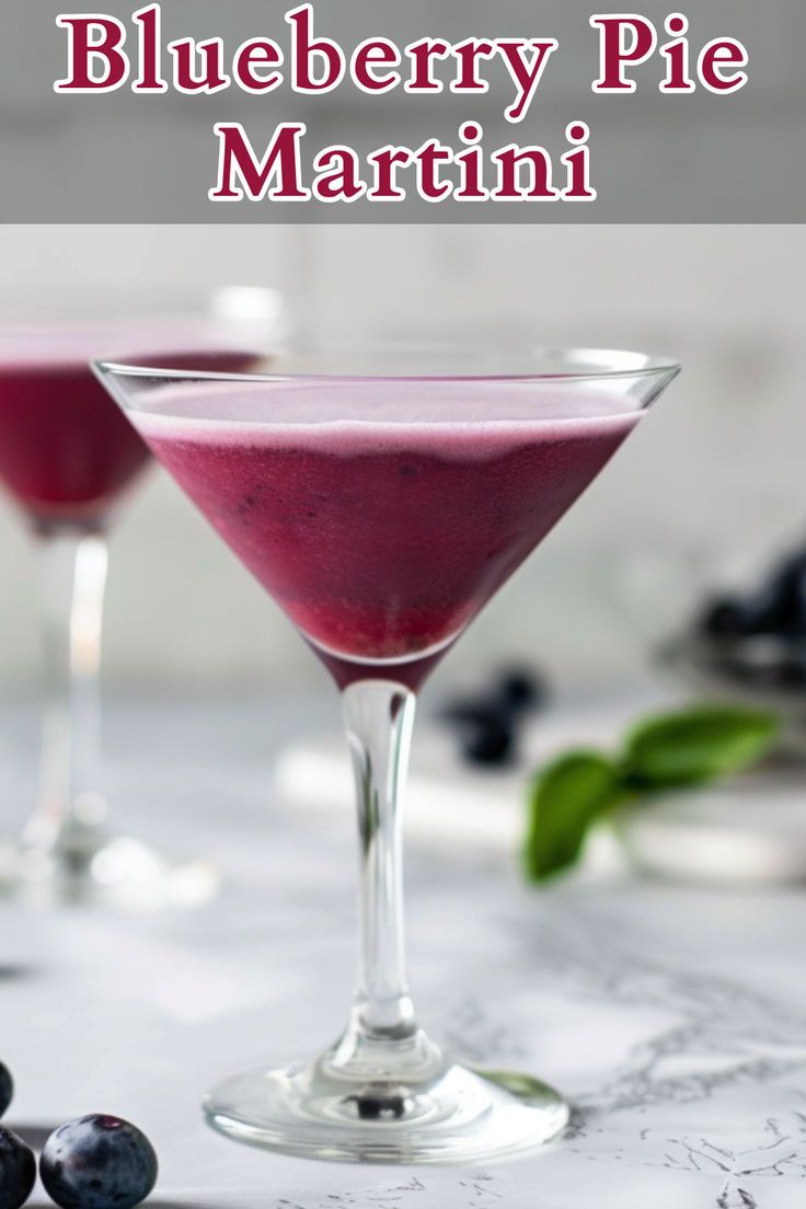 two blueberry pie martinis in coupe glasses with fresh berries on the side and text overlay that reads, blueberry pie martini