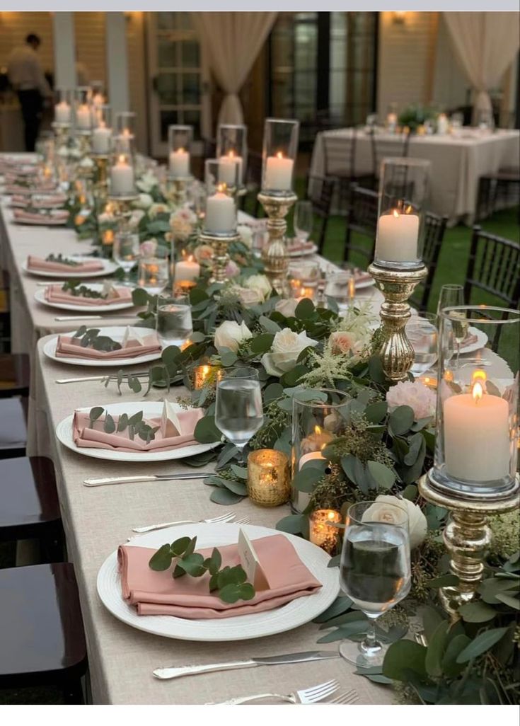 a long table is set with candles and place settings