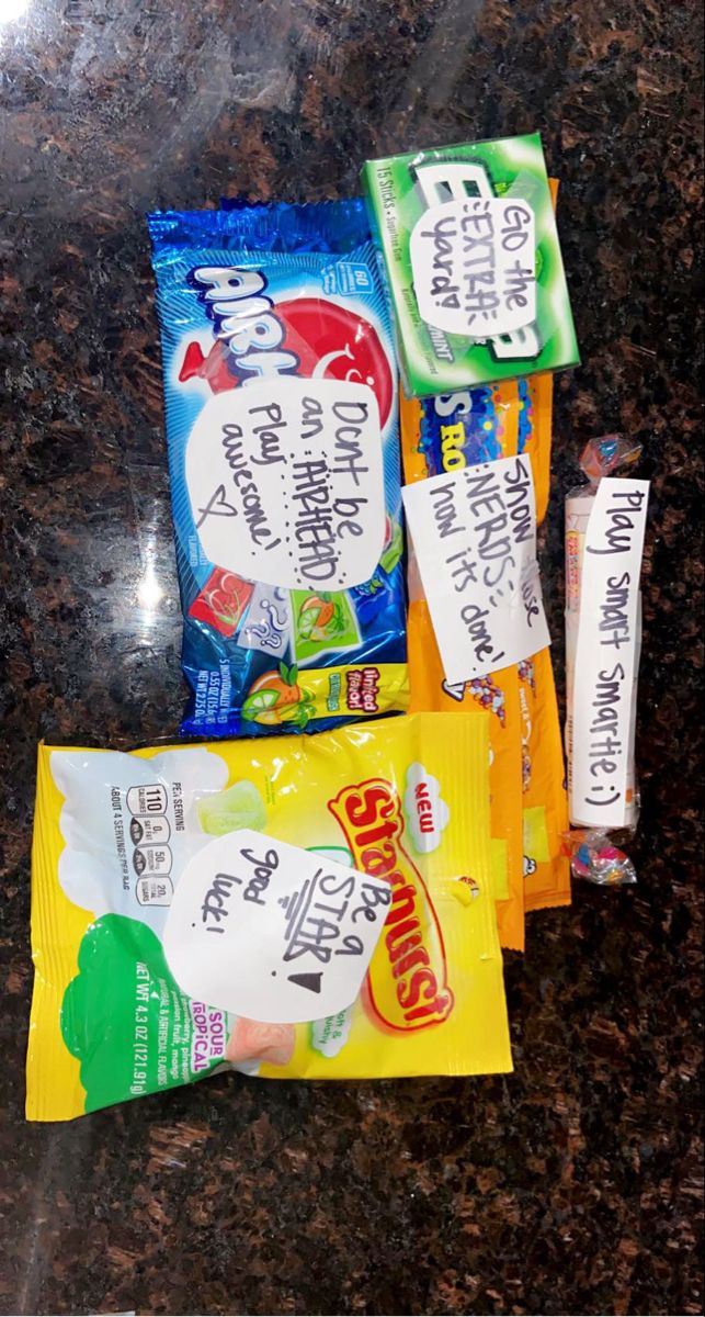 three bags of candy sitting on top of a counter next to each other with writing on them