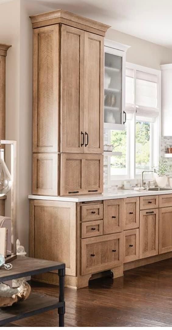 a large kitchen with wooden cabinets and white appliances in the middle of it's living room