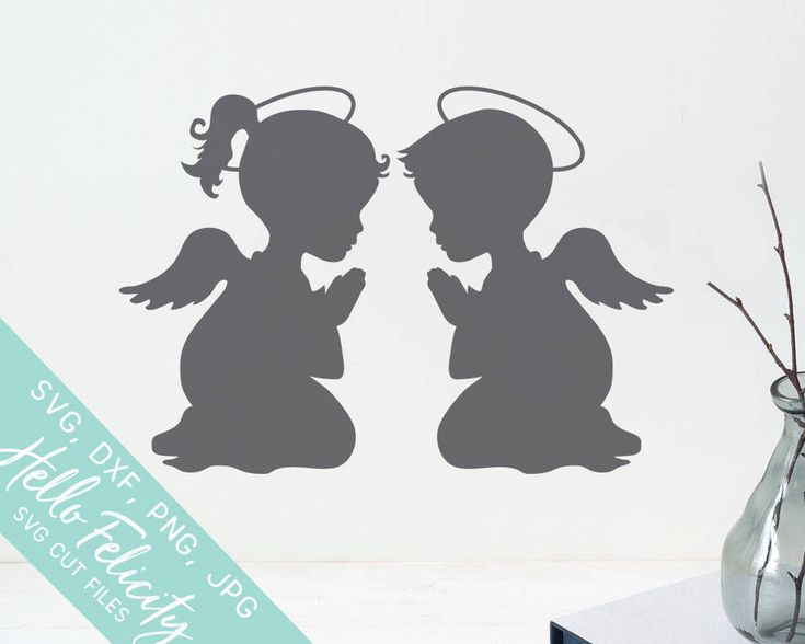 the silhouettes of two angels are next to a vase with flowers