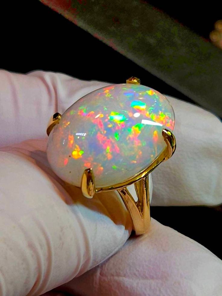 Very bright beautiful, I can't help imagining an Australian white opal of this size and color, you would need a second mortgage to own it, the only difference is you shouldn't get it wet for extended period of time. I have now sold literally thousands of opals and only a couple complaints of chafing. Large oval white  fire opal 16x23mm 18cts. Mounted on a large simple solitaire solid 14k gold ring, I like the simplicity and solidness of this ring. It's heavy for its size. Prongs will be set when Red Jewerly, Large Engagement Rings, Black Opal Jewelry, Black Fire Opal, Australian Opal Jewelry, White Opal Ring, Rainbow Opal, Ring Opal, Fire Opal Ring