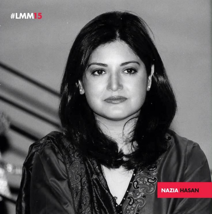 a black and white photo of a woman with long dark hair wearing a leather jacket