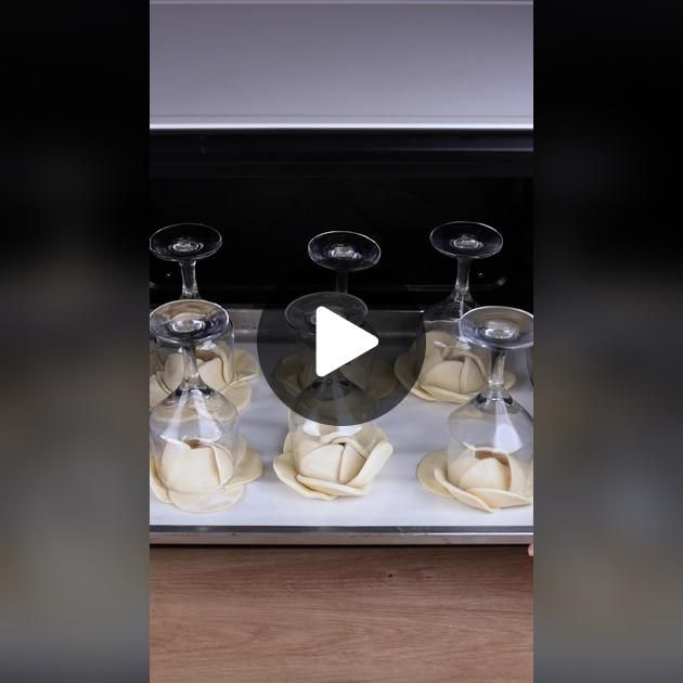 a video demonstrating how to make ravioli in the oven with wine glasses on top