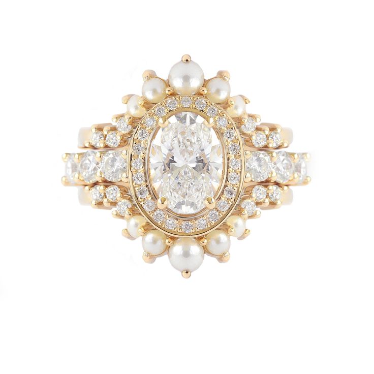 a diamond and pearl ring with two rows of diamonds in the center, surrounded by pearls