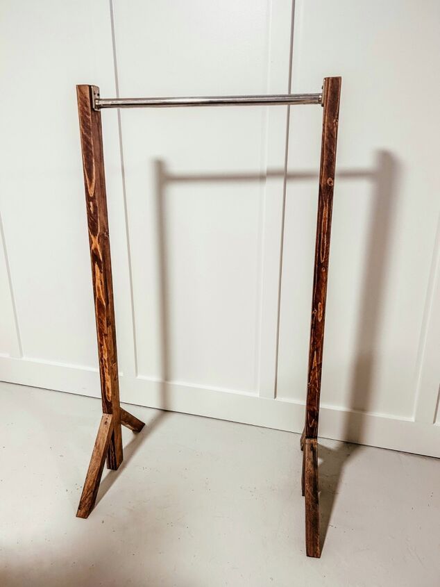 a pair of wooden poles sitting in front of a white wall