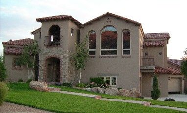 a large house with lots of windows and landscaping