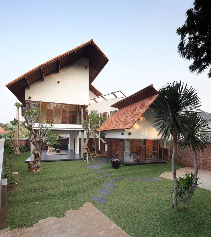 the house is surrounded by lush green grass