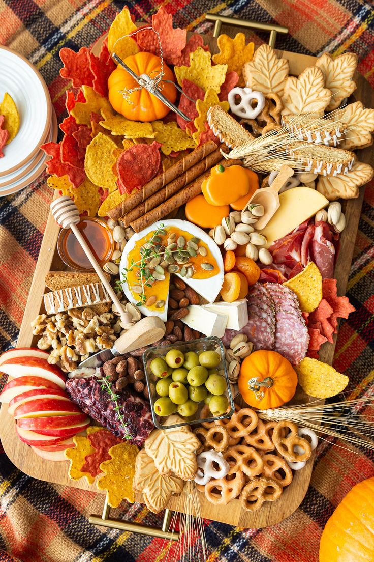 a platter filled with lots of different types of food and nuts on top of it