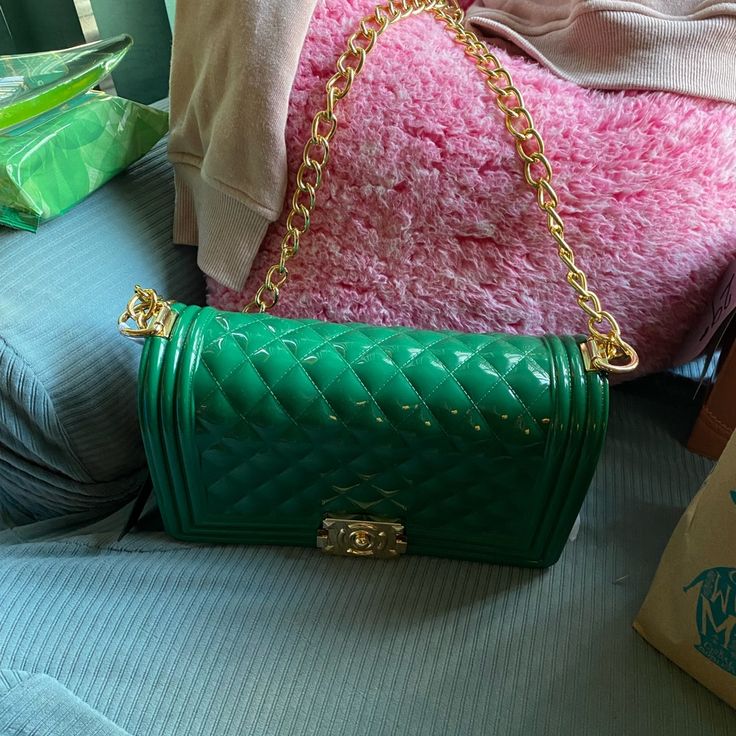 Large Pvc Bag With Shorter Chain. Gold Accents And Double Tension Closure. Luxury Green Bag With Chain Detail, Luxury Green Bag With Chain, Luxury Green Chain Bag, Chic Green Shoulder Bag With Chain, Green Shoulder Bag With Chain Strap As Gift, Elegant Green Bags With Chain Strap, Elegant Green Bag, Green Shoulder Bag With Gold-tone Hardware, Trendy Travel Clutch With Chain Strap