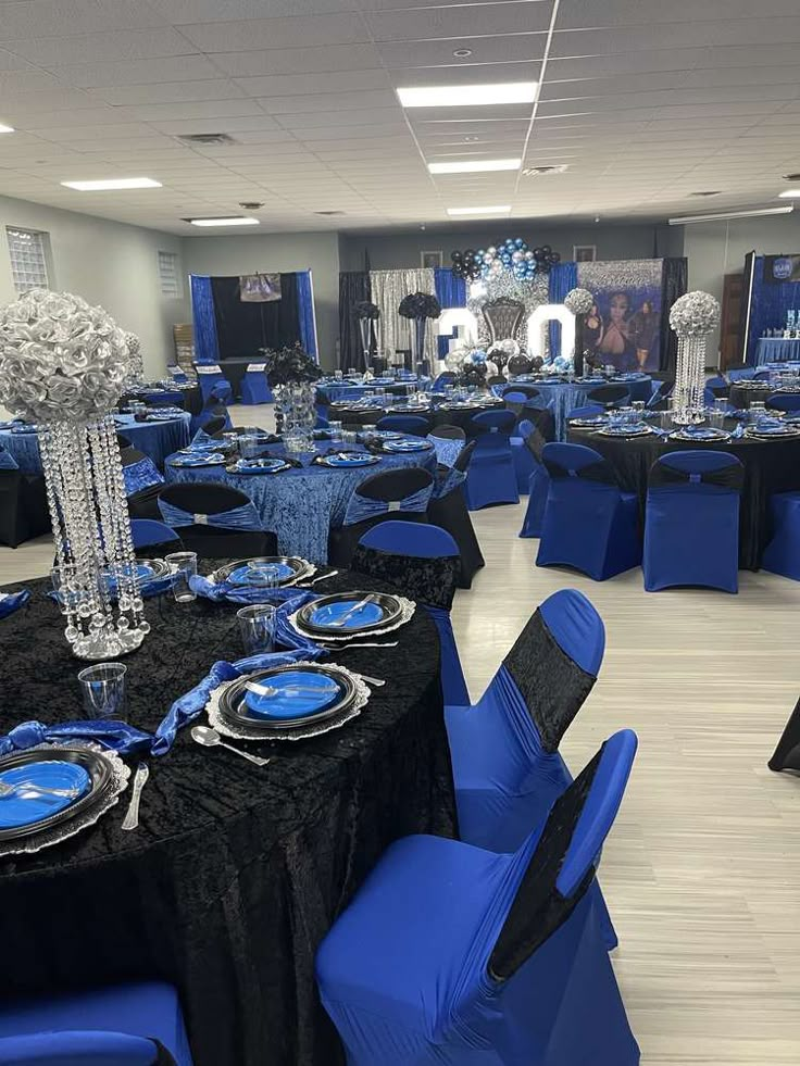 a banquet room with blue and black table cloths