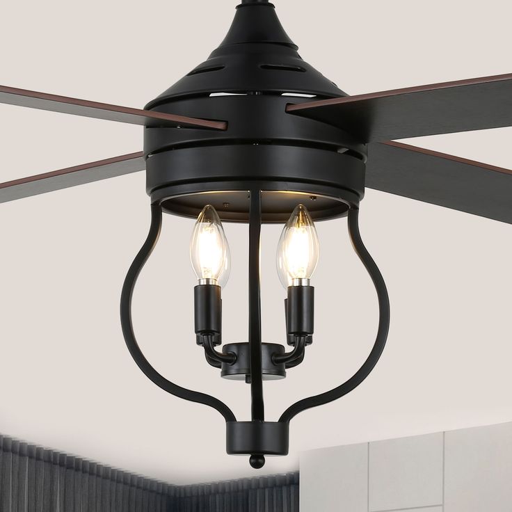 a ceiling fan with two light bulbs hanging from it