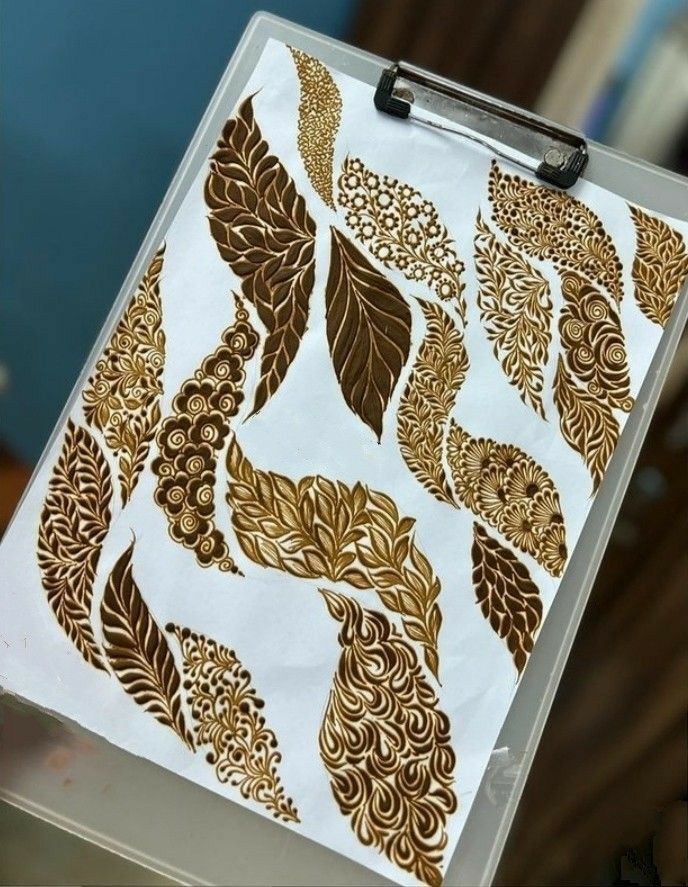 a clipboard with gold leaf designs on it