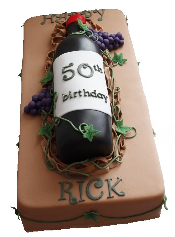 a birthday cake made to look like a wine bottle with grapes on it and the number fifty