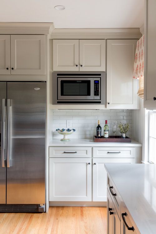 a kitchen with stainless steel appliances and white cabinets