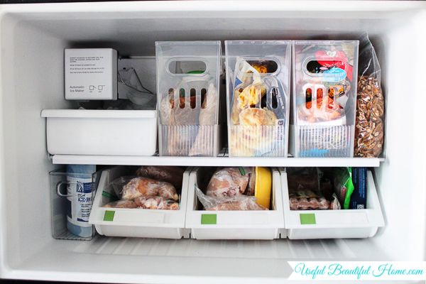 an open refrigerator filled with lots of food and storage containers on top of it's shelves