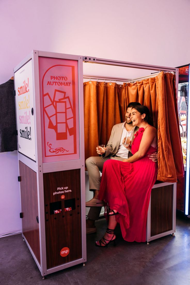 a man and woman are sitting in a booth