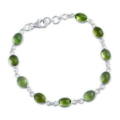 The August birthstone peridot exudes elegance in a handcrafted bracelet from Bhavesh. The cabochon gemstones are set in sterling silver creating an extraordinary contrast. .925 Sterling silver Adjustable Elegant Lime Green Jewelry, Green Cabochon Bracelets As A Gift, Green Cabochon Bracelets For Gift, Round Peridot Jewelry With Stones, Round Peridot Stone Jewelry, Green Gemstone Bracelets, Elegant Peridot Jewelry With Natural Stones, Elegant Silver Peridot Bracelets, Adjustable Peridot Bracelet