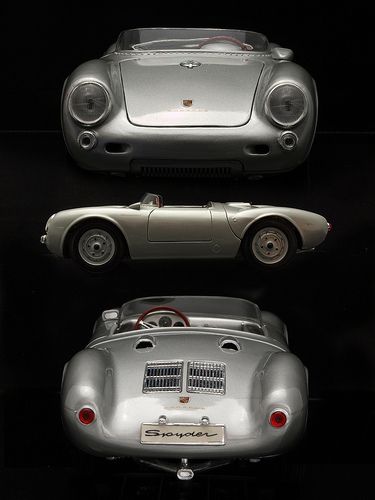 three different types of cars on display in a black room with one car facing the camera