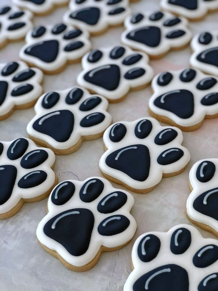 decorated cookies with black and white paw prints