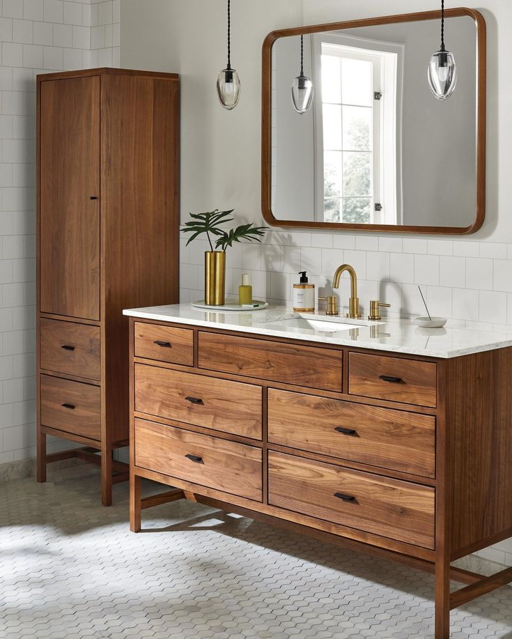 a bathroom with two sinks and a large mirror over it's counter top that is made out of wood