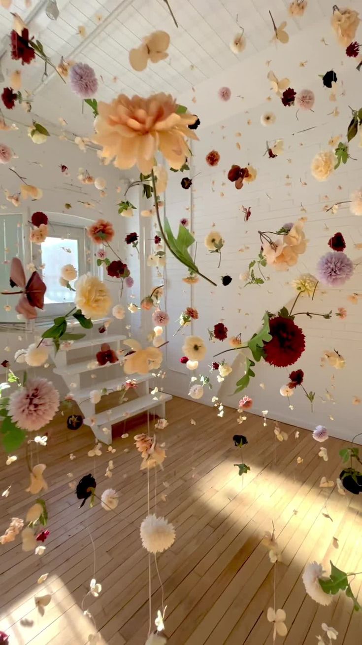 a room filled with lots of flowers floating in the air