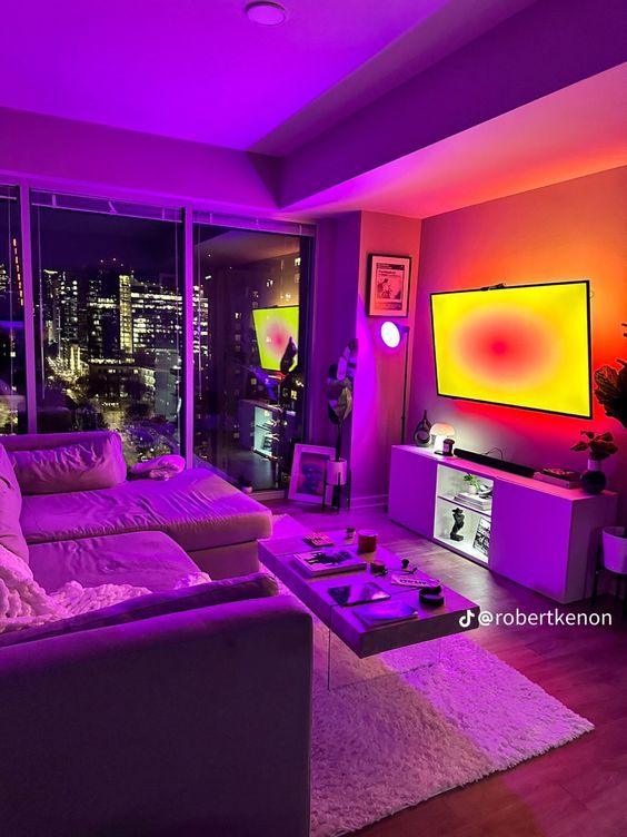 a living room filled with furniture and purple lighting