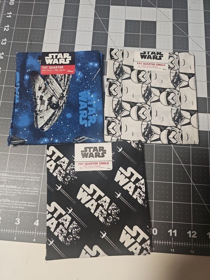 three star wars napkins sitting on top of a cutting board next to each other