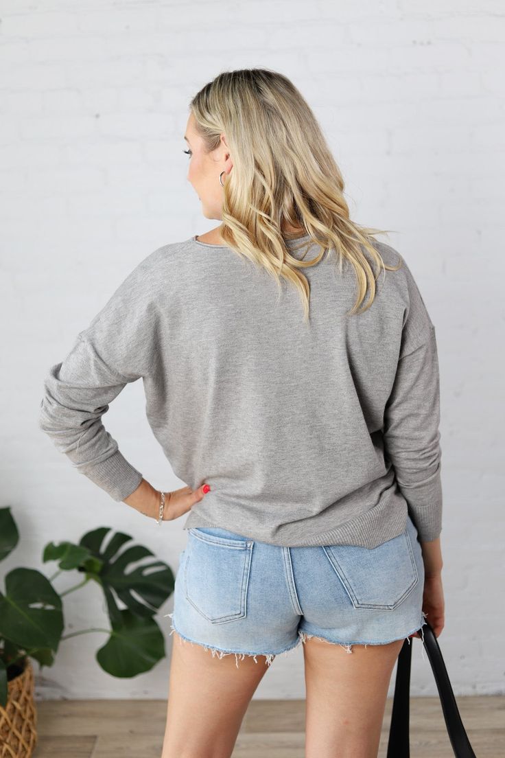 Introducing the Clarice Cozy Sweater, the perfect blend of style and comfort. With a round neck and seam detailing, this sweater is designed for a relaxed fit and features cozy knit fabric for those chilly days. Complete with ribbed hem and cuffs, side slits, and available in Heather Grey, Black, Oatmeal, & Ivory. Pair with jeans or shorts for a versatile look. Round neck Seam detailing on center front Long sleeves, Drop shoulder Cozy Knit Pullover, Relaxed Fit Ribbed hem and cuffs Side slits, H Oversized Casual V-neck Sweater For Loungewear, Cozy Ribbed V-neck Long Sleeve Sweater, Cozy Soft Knit V-neck Sweater For Layering, Ribbed V-neck Sweater For Winter Loungewear, Fall Long Sleeve Top With Ribbed Neckline, Long Sleeve Top With Ribbed Neckline For Fall, Comfy Everyday Tops With Ribbed Cuffs, Comfy Tops With Ribbed Cuffs For Everyday, Oversized Ribbed Sweatshirt For Layering