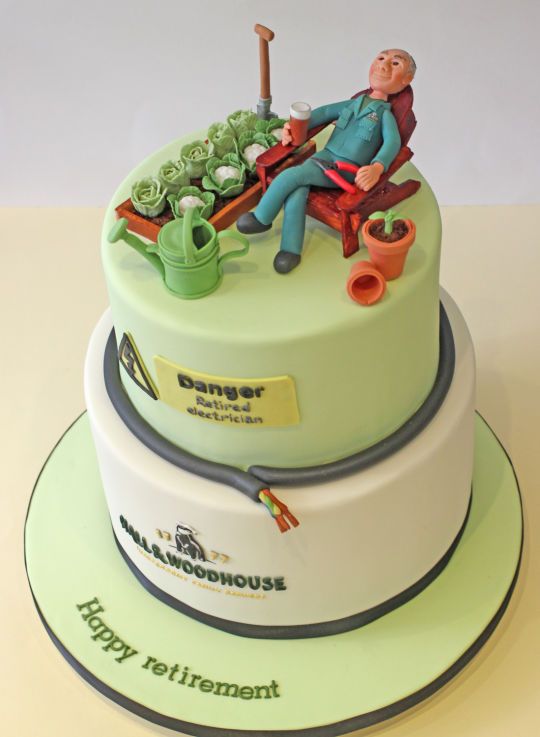 there is a cake that has a man sitting on top of it with gardening tools