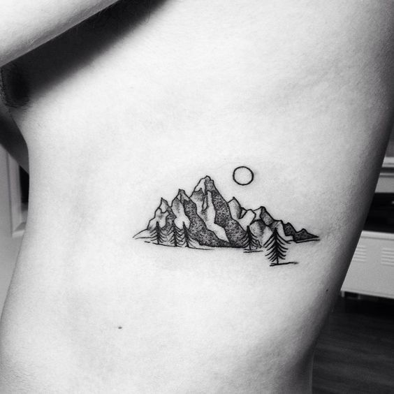 a small mountain tattoo on the stomach