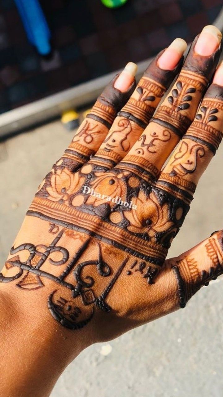 a woman's hand with henna tattoos on it