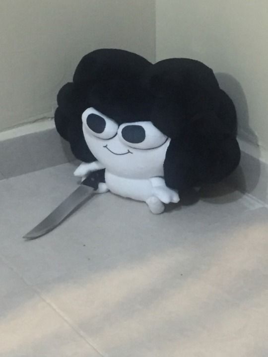 a stuffed toy with a knife on the floor