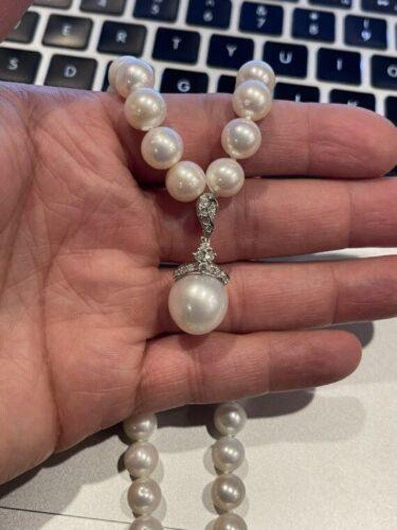 14k YG & 18k White Gold Round Pearl & Diamond Necklace24 Inches Center Pearl 13.5mm  8.5mm Pearls This is an timeless gold diamond and pearl necklace. If you have any questions or concerns please message me and I will get back to you as soon as possible! serial number: AJ0541536 A Luxury Pearl Necklace With 17 Jewels, Pearl White Jewelry With Diamond Accents For Formal Occasions, Formal Pearl White Jewelry With Diamond Accents, Diamond Jewelry With Pearl Charm For Anniversary, White Pearl Diamond Necklace With Pearl Chain, Pearl White Akoya Pearl Jewelry With Diamond Accents, Luxury Pearl Chain Jewelry For Anniversary, Luxury Pearl Chain Necklace For Anniversary, Yellow Gold Pearl Jewelry With Brilliant Cut