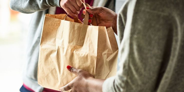 two people holding shopping bags in their hands