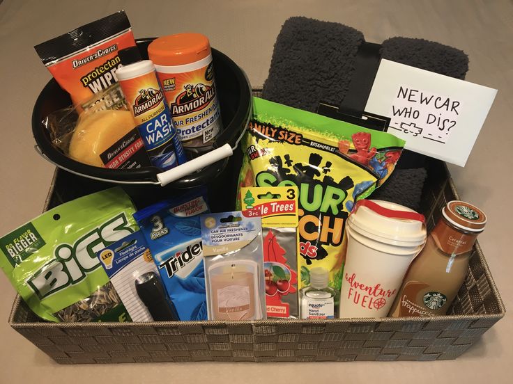 a basket filled with snacks and condiments sitting on top of a counter next to a sign