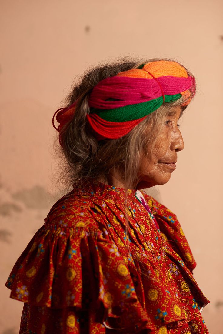 an old woman wearing a colorful head piece