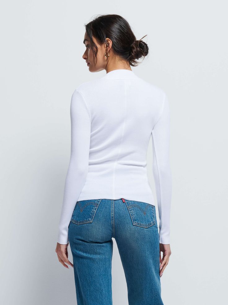 The perfect white, mock neck in our responsible Organic Rib. Use it as a layering piece or wear on it's own. (This one comes in White.) | Women's Gina Long Sleeve Top in White | Ethical Essentials Elegant Stretch White Turtleneck, Elegant Fitted White Mock Neck Top, Elegant White Stretch Turtleneck, Elegant White Fitted Mock Neck Top, Chic White Long Sleeve Turtleneck, Casual White Spring Turtleneck, Casual White Turtleneck For Spring, White Mock Neck Top For Fall, Fitted White Turtleneck Top