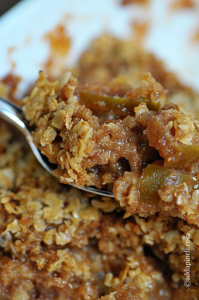 a close up of food on a spoon in a bowl with cereal and other items