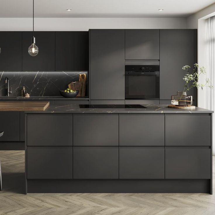 a modern kitchen with black cabinets and marble counter tops