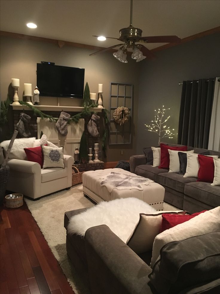 a living room filled with furniture and a flat screen tv mounted on the wall over a fireplace