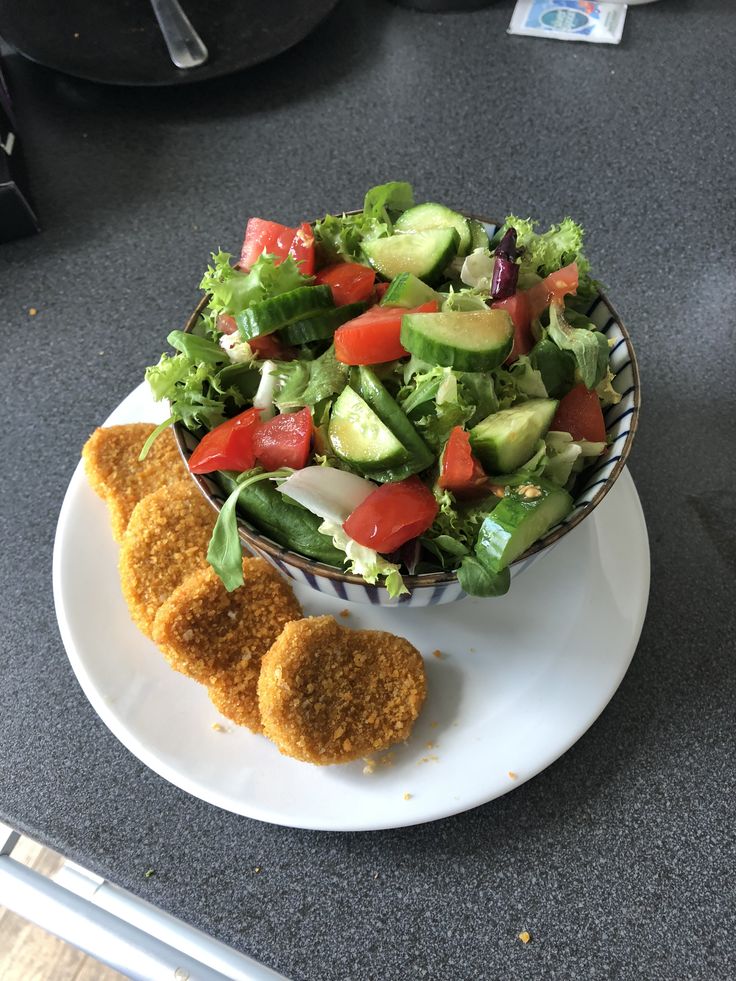 a salad and two pieces of bread on a plate