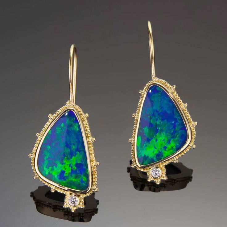 Escape into the beauty of the sea with these stunning Opal & Diamond Earrings. Crafted from 18K granulated gold and adorned with gorgeous blue-green opals and two small diamonds, these earrings shimmering like the rolling waves of a distant shore. Treat yourself to a little oasis with these charming ocean-inspired earrings 18KY granulated earrings with 2 opal doublets weighing 8.42cts and accented with .06cttw of VS/GH diamonds.Dimensions: 7/8” x 9/16” (24mm x 15mm) excluding earwire Formal Opal Gemstone Earrings, Opal Jewelry In Yellow Gold With Matching Earrings, Yellow Gold Opal Jewelry With Matching Earrings, Elegant Ethiopian Opal Jewelry With Gemstone Accents, Elegant Ethiopian Opal Earrings As Gift, Elegant Green Ethiopian Opal Jewelry, Yellow Gold Opal Gemstone Earrings, Ocean Inspired Earrings, 18k Gold Earrings