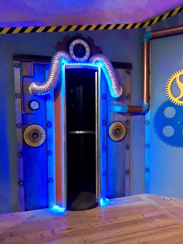 an open door in the middle of a room with blue and yellow lights on it